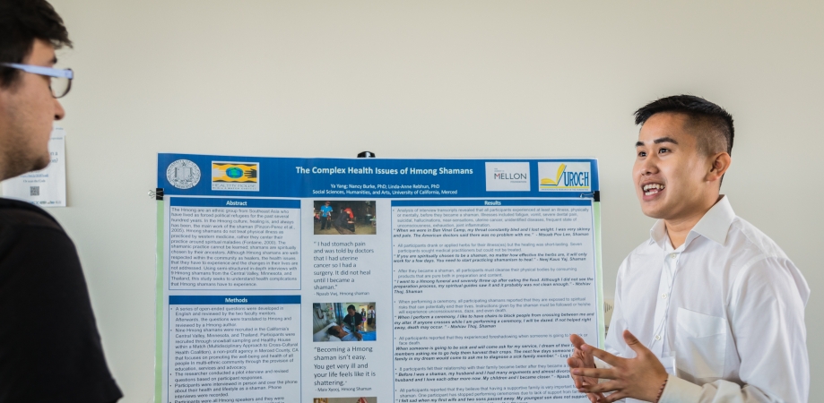 student presenting poster at annual symposium
