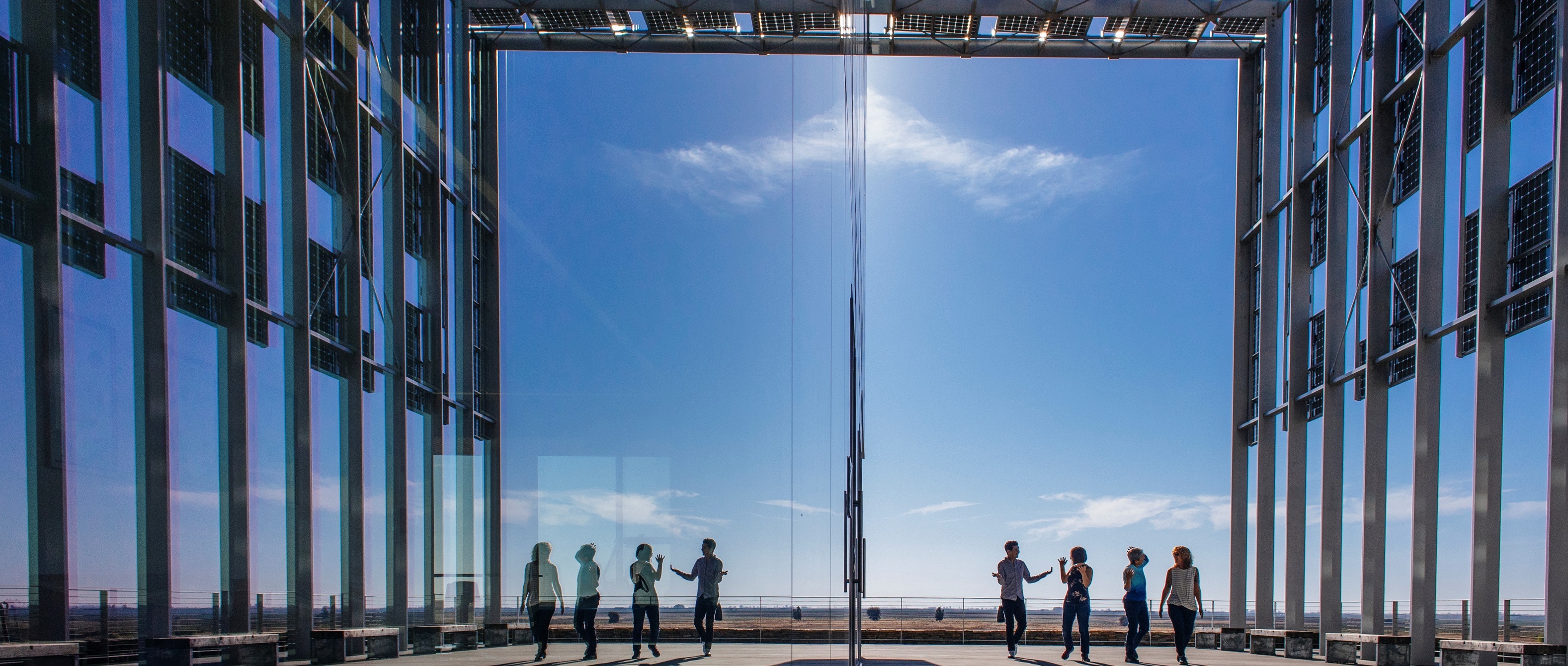 studens and faculty talking near a building